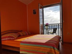 een slaapkamer met een bed en een balkon bij Grandpa's dream in Lokva Rogoznica