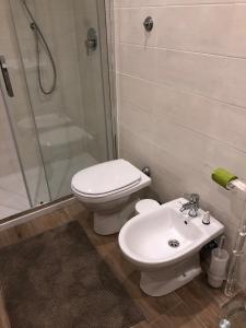 a bathroom with a toilet and a shower and a sink at San Lorenzo University flat in Rome