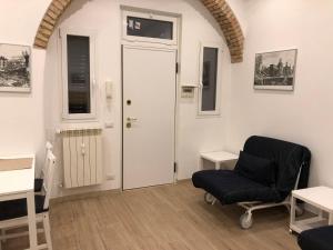 a living room with a chair and a door at San Lorenzo University flat in Rome
