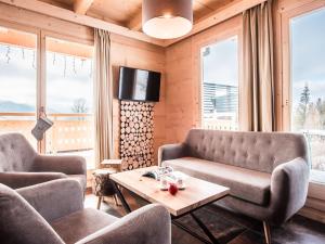 a living room with a couch and a table at TatryTop Osada Staszel&oacute;wka z jacuzzi i sauna in Kościelisko