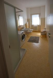 a bathroom with three sinks and a washing machine at Vitali Apartment JR in Bellagio +8 photos