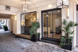 a store front with potted plants in front of it at Doisy Etoile - Orso Hotels in Paris