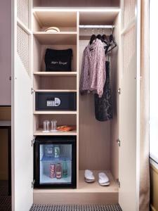 a walk in closet with a tv in it at Doisy Etoile in Paris