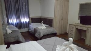 Postel nebo postele na pokoji v ubytování Hotel Livia