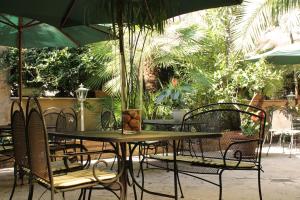 an outdoor table and chairs with an umbrella at Hotel Villa Delle Rose in Rome