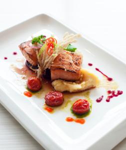 a white plate with a piece of food on it at Promenade Hotel Bintulu in Bintulu