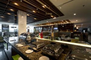 a restaurant kitchen with stainless steel counter tops at Promenade Hotel Bintulu in Bintulu