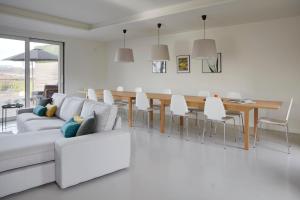 a living room with a couch and a table and chairs at Villa Enea by FeelFree Rentals in Donostia-San Sebastián
