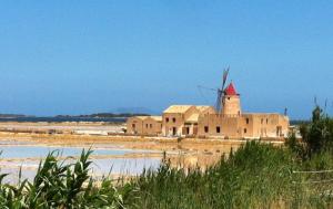 an old building with a windmill in the desert at Liberty House in Marsala