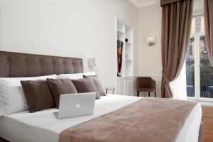 Posteľ alebo postele v izbe v ubytovaní La Fontanina Suites