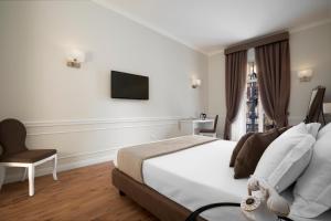 Posteľ alebo postele v izbe v ubytovaní La Fontanina Suites
