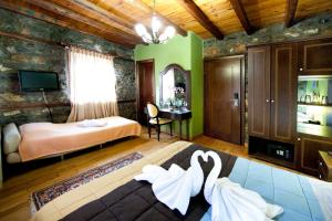 a bedroom with a bed and a desk in a room at Chalet Lithos in Palaios Agios Athanasios