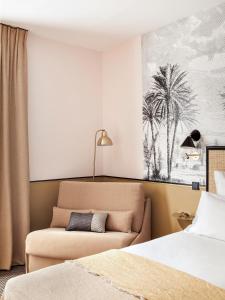 a hotel room with two beds and a couch at Doisy Etoile in Paris