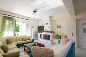 uma sala de estar com sofás e uma lareira em Mertoula House em Zakynthos
