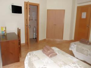 Postel nebo postele na pokoji v ubytování Hostal Abastos