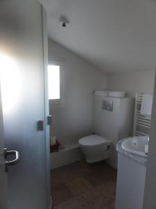 a bathroom with a toilet and a sink at Hotel La Longue Vue in Gennes