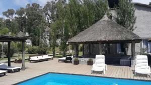 a patio with a gazebo and a swimming pool at Palmas de la Pedrera maravillosa casa in Rocha