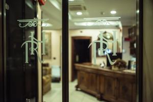 a glass door with a reflection of a room at Hotel Robinson in Rome