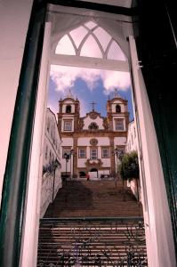 a view of a building through a window at Luna Bahia Pousada in Salvador