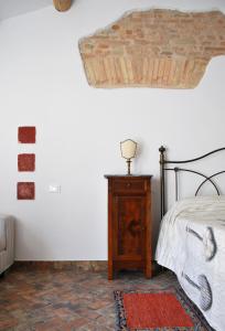 a bedroom with a bed and a table with a lamp at La Casetta nel Borgo in Faenza