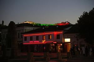 a building with a neon sign on it at night at Hotel Varosha in Lovech