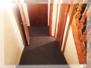 a stairway leading to a hallway with a door at Hostel Sakharov & Tours in Yerevan