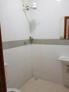 a bathroom with a shower and a sink at Hotel Cabo Finisterra in Rio de Janeiro