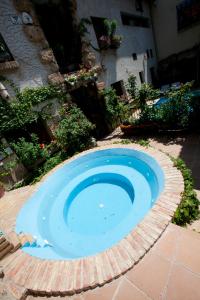 a small blue pool in the middle of a yard at Casa Rural Capricho del Valle in Arroyo Frio