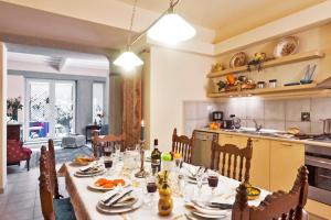 a kitchen with a table and a dining room at Via dei Fossi apartment in Florence
