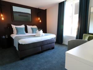 Postel nebo postele na pokoji v ubytování Hôtel-Restaurant Bel Ami