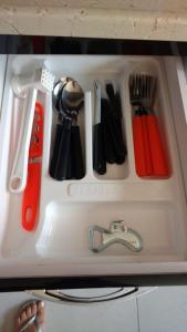 a tray of kitchen utensils on a counter top at Chales Ilhabela ll in Ilhabela