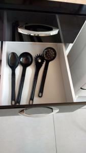 a drawer with four different types of spoons at Chales Ilhabela ll in Ilhabela
