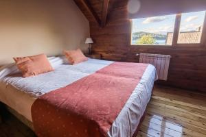 a bedroom with a large bed with a large window at Cabañas Las Marias Del Nahuel in San Carlos de Bariloche