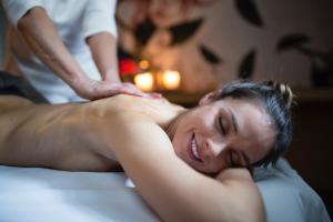 a woman getting a massage from a therapist at ElisabethHotel Premium Private Retreat- Adults only in Mayrhofen