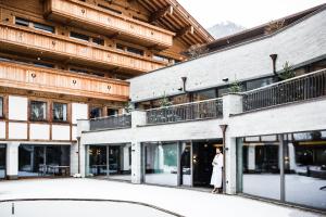 a woman standing in front of a building at ElisabethHotel Premium Private Retreat- Adults only in Mayrhofen