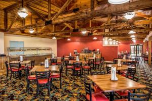 an empty restaurant with wooden tables and chairs at Lodge of the Ozarks in Branson