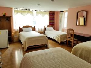 A bed or beds in a room at Travellers Inn