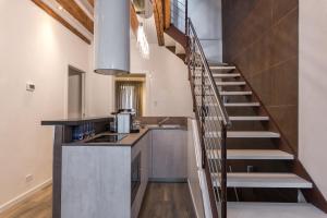 a kitchen with a staircase leading up to a loft at La Loggia della Luna in Venice