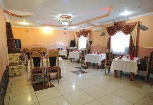 a dining room with tables and chairs in a restaurant at Hotel Star in Stryi