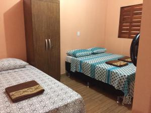 Un pat sau paturi într-o cameră la Residencial Sibaúma