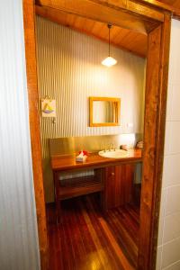a bathroom with a sink and a mirror at 1770 Beach Shacks in Seventeen Seventy