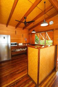 a kitchen with wood floors and wooden cabinets at 1770 Beach Shacks in Seventeen Seventy