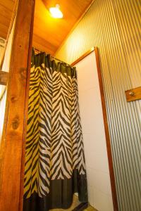 a shower curtain is hanging on a wall at 1770 Beach Shacks in Seventeen Seventy