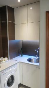 a kitchen with a sink and a washing machine at 2V LUXURY APARTMENT NEAR BEACH in Puerto del Rosario