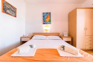 Postel nebo postele na pokoji v ubytování Apartments Zanze
