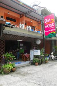 a building with a seafood world sign in front of it at Seaworld Guesthouse in Ao Nang Beach