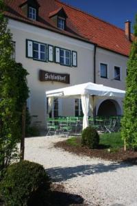 a building with a white tent in front of it at Schlosshof anno 1743 in Wolnzach