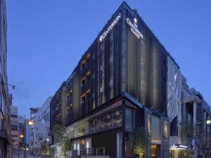 a large building on a city street at night at The Centurion Classic Akasaka in Tokyo