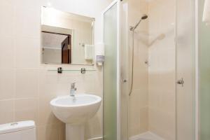 a bathroom with a sink and a shower at Hotel Buzuluk in Buzuluk