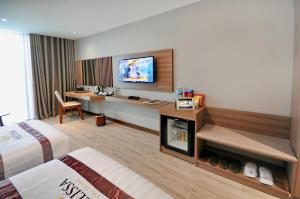 a hotel room with a bed and a fireplace at Melissa Hotel Nha Trang in Nha Trang